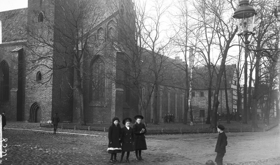 svartvitt fotografi med barn framför klostret från tidigt 1900-tal