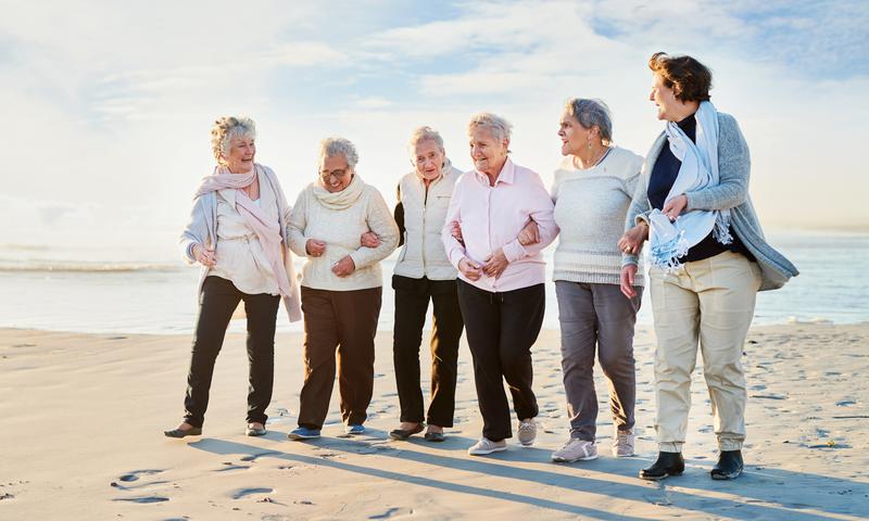 Shot of a group of senior women going for a walk along the beach